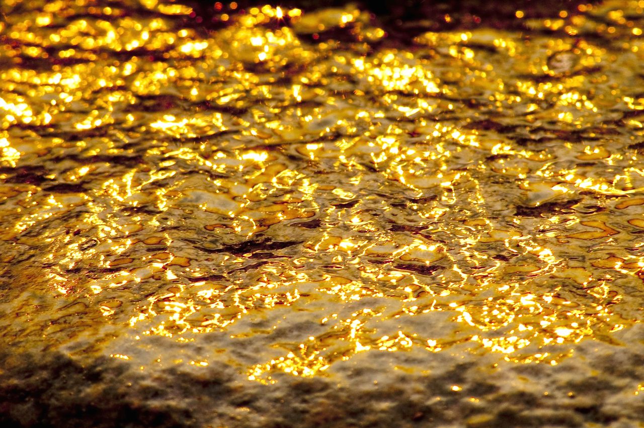 Products A mesmerizing display of golden light reflected on water at Steep Rock, Manitoba, Canada.