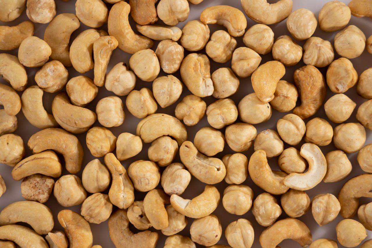 Products Close-up of assorted cashew and macadamia nuts, showcasing texture and variety.